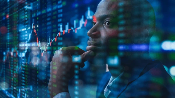 Black stock market trader checking dividend stocks